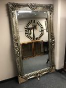 A large ornate silvered mirror 125 cm x 214 cm