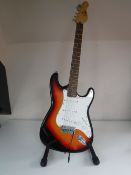 An Encore electric guitar on stand