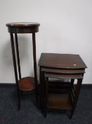A nest of three tables and a plant stand