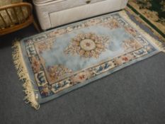 A blue fringed embossed Chinese rug