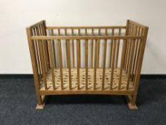 An oak Arts and Crafts cot by Liberty of London