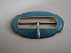 A silver and enamel belt buckle