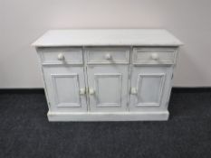 A painted pine triple door sideboard
