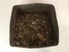A tin of foreign and British coins