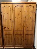 A pine triple door wardrobe and a pine double door wardrobe