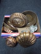 A box of antique copper jelly moulds and wall plaques
