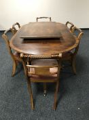 A Regency style yew wood dining table with leaf and six chairs