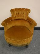 A Victorian armchair upholstered in gold button fabric