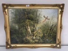 A gilt framed oil painting, Pheasant in flight, signed Ferdinand.
