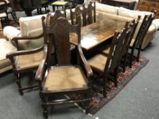 A 6' 2'' oak refectory dining table, together with a set of eight Arts and Crafts chairs by Wm.