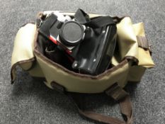 A camera bag - Praktica TL1000 in case together with two lenses.