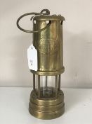 A brass lamp and limelight miner's lamp