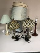 Two Tiffany style table lamps with shades together with four further table lamps with shades.