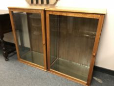 A pair of oak glazed display cabinets, width 66 cm.