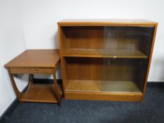 A set of teak sliding door bookshelves and a teak side table