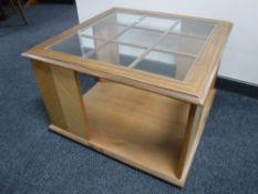 A square teak glass topped coffee table