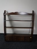 A set of mahogany wall shelves fitted six drawers