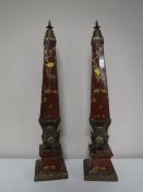 A pair of ornate ormolu mounted obelisks decorated with figures of elephants