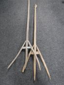 Two rustic hay forks