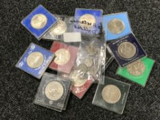 A collection of twelve Crowns (modern) and six quarter dollars.