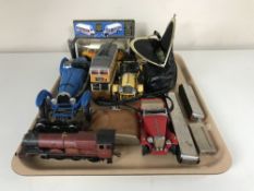 A tray of die cast vehicles, mouth organs,