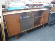 A set of mid 20th century teak sliding door shelves