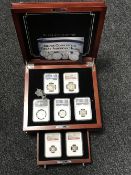 A mahogany display case with drawer and key - Silver coins of the Great American Hoard,