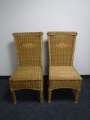 A pair of wicker high back chairs