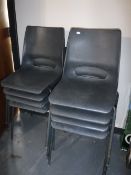 Eight plastic stacking chairs