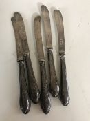 A set of five silver butter knives
