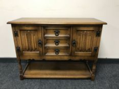 An oak linen fold side cabinet