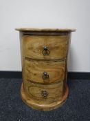 A hardwood d-shaped bedside chest