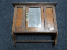 An oak mirrored Arts and Crafts wall cabinet