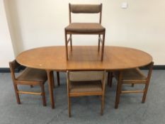 A mid 20th century teak extending dining table and four chairs