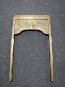 An antique brass fire surround