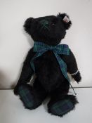 A Steiff black mohair bear - Black Watch musical bear, length 30 cm.