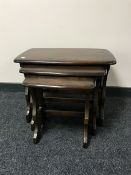 A nest of three Ercol elm tables