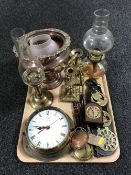 A tray of brass ware, oil lamps, miniature mantle clock, copper twin handled pot,