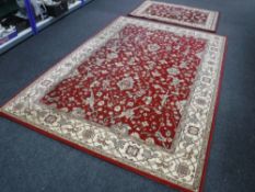 Three machine made rugs on red round