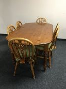 A pine dining table and six pine wheel back chairs