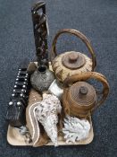 A tray of tribal art, wicker lidded basket, sea shells, plated cigarette case,
