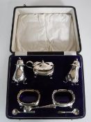A cased five piece silver cruet set together with two plated spoons (one pot missing liner)