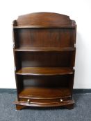 A set of mahogany open shelves fitted a drawer