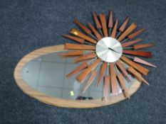A teak sun burst battery operated clock and unframed mirror on board