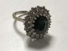 An 18ct gold sapphire and diamond cluster ring, approximately 1.6ct, size M.