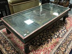 A Saudi Arabian coffee table, made from a solid lead door within a painted wooden frame,