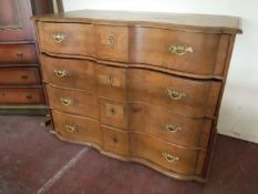 A 19th century heavy oak serpentine fronted four drawer chest