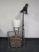 A metal spark guard together with a magazine rack,