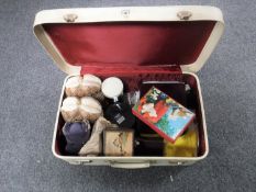 A canvas suitcase containing Guinness bar top, jewellery boxes, paperweight,
