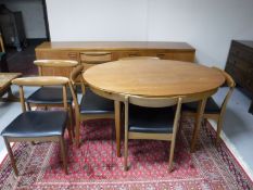 A teak eight piece dining room suite comprising of low sideboard,